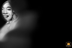 At W Bangkok, the glowing bride’s joyful face is reflected in a round handheld mirror, captured in a minimalist black-and-white composition that emphasizes her happiness and anticipation during the getting ready process.